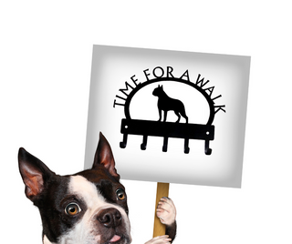 A Boston Terrier holding a sign with a Boston Terrier leash hanger with the words Time for a Walk