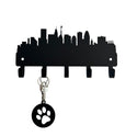 A silhouette of Baltimore city skyline, cut from metal and with 5 hooks for hanging keys. Shows keys and a keychain on 1 hook. 