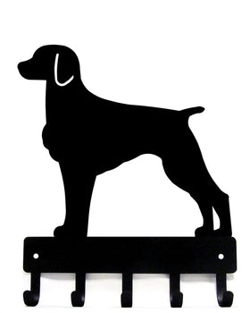 Black silhouette of a dog on a key holder with hooks on a white background