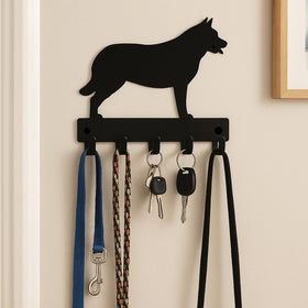 Australian Cattle Dog wall hook with keys and leashes on a beige wall.