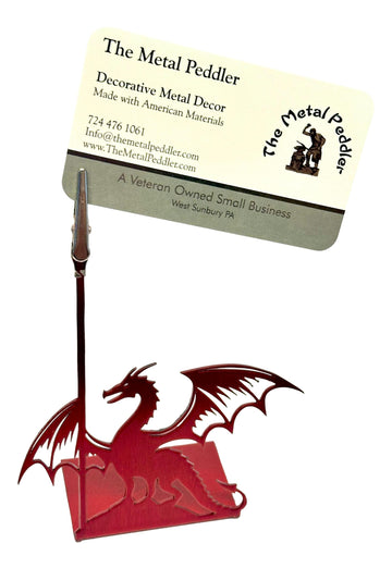 Decorative metal dragon design on a stand with 'The Metal Peddler' business card.