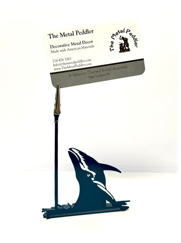 Decorative metal whale-shaped business card holder with 'The Metal Peddler' branding on a white background.