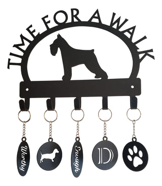 A key holder that says Time for a Walk with a dog silhoutte. On each hook there is a different metal keychain, with designs such as a dog, a letter D, a paw print, the word Worthy, and the word Enough.