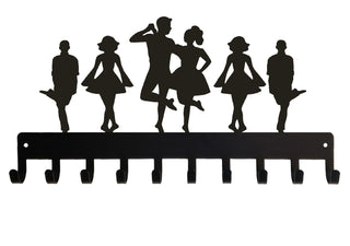 A metal medal hanger with 6 Irish Dancers on top of it.