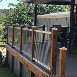 A deck rail with copper pyramid caps on the posts.