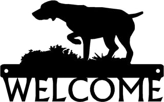 A black welcome sign with the silhouette cut out of a German Shorthaired Pointer on Point. 