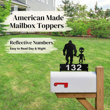 Mailbox with alien and Bigfoot design on top, featuring reflective house numbers.