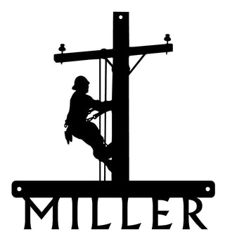 A sign cut from metal with a lineman climbing a pole, and the word MILLER is cut below it. 