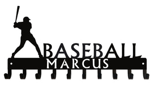 A medal hanger with a baseball batter silhouette and 10 hooks. The word Baseball is on top of the hooks and a boy's name is cut into the hook rail.