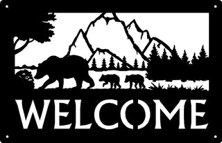 A metal welcome sign with bears and mountains cut out