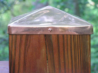 Copper pyramid cap on a wooden post