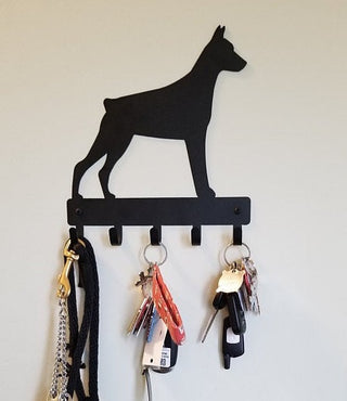 Doberman key hanger with 5 hooks and keys hanging from it.