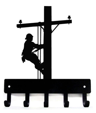 a key holder with 5 hooks and the silhouette of a lineman.