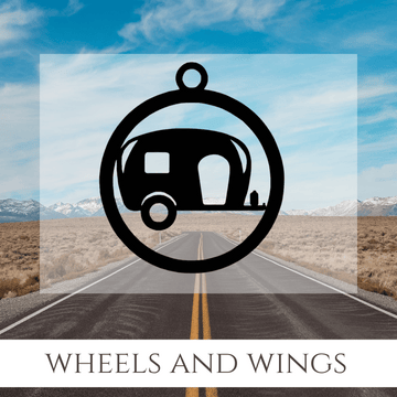 An open road with blue sky and mountains. An image of a camper on a key chain. The words Wheels and Wings.