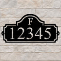 Heritage Monogram personalized metal address sign with custom house numbers on a stone wall