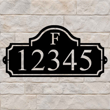 Heritage Monogram personalized metal address sign with custom house numbers on a stone wall