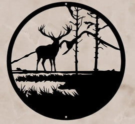 An Elk and trees with a mountain background circled in a metal frame 'Elk in the Mountains' - Metal Wall Art