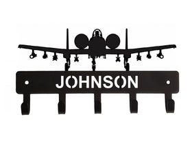 Black airplane-shaped wall hook with 'JOHNSON' branding on a white background