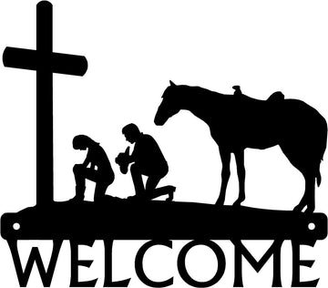 Cowboy & Cowgirl at the Cross Welcome Sign