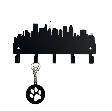 A silhouette of Baltimore city skyline, cut from metal and with 5 hooks for hanging keys. Shows keys and a keychain on 1 hook. 