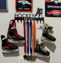 A 10-hook hockey medal hanger customized with a name Brady in the bar.