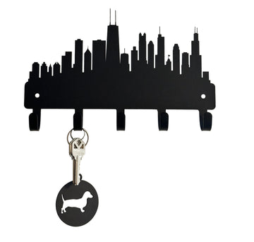 Metal silhouette of Chicago city skyline. It has 5 hooks and a set of keys with a Dachshund keyring hanging on it.