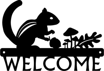 Black welcome sign with a chipmunk silhouette an acorn, mushrooms and an oak leaf