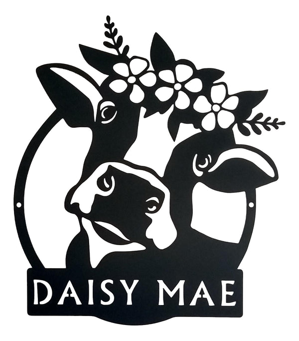 Black cutout of a cow with flowers and 'DAISY MAE' text on a white background