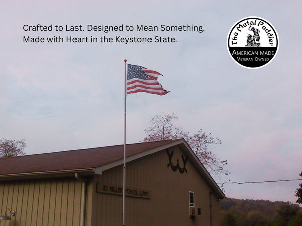 American flag on a pole in front of a building with text and logo about 'The Metal Peddler'.