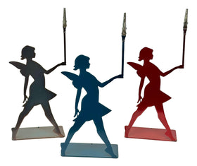 Three silhouetted fairy figures on stands in black, blue, and red against a white background.