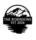 Features mountain scenery with a mirrored lake reflection beneath the sign.. Personalized design with mountain and boat silhouette, 'The Robinsons Est 2026' text on a white background.