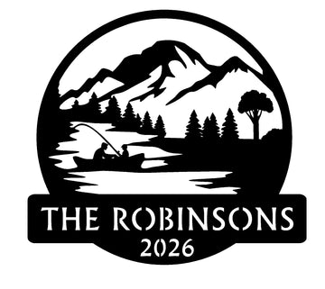Features a fisherman on the water with mountain and lake scenery. Personalized design with mountains, trees, and a lake, featuring 'The Robinsons 2026' text.