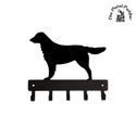 Black metal Flat-Coated Retriever dog silhouette with a key holder on a white background, branded 'The Metal Peddler'.