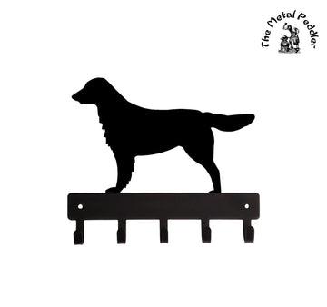 Black metal Flat-Coated Retriever dog silhouette with a key holder on a white background, branded 'The Metal Peddler'.