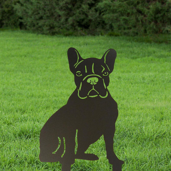 Black metal French Bulldog dog sculpture on grass