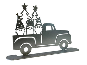 3 gnomes in the back of a silver pickup truck