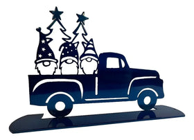 3 gnomes in the back of a blue pickup truck