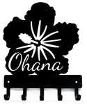 Black metal key holder with 'Ohana' text and flower design on a white background