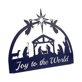 Silhouette of a nativity scene with 'Joy to the World' cut from the metal