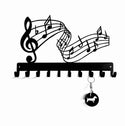 Decorative key holder with musical notes design on a white background