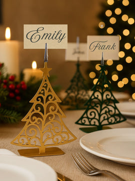 Decorative table name cards on Christmas tree stands with a festive background.