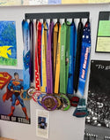 Plain medal hanger with 10 hooks and medals, wall mounted.