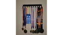 Plain medal hanger with 10 hooks and medals, wall mounted.