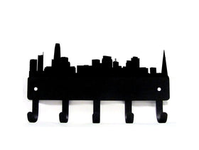Black metal wall hook rack shaped like a city skyline, featuring five hooks at the bottom, shown against a plain white background.