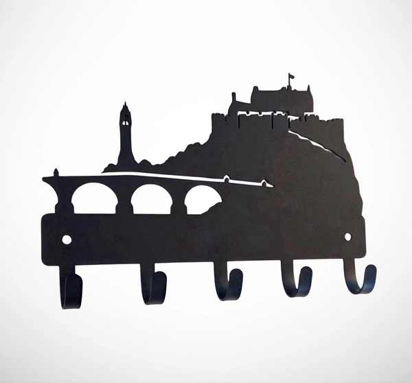 Black metal wall hook rack shaped like a city skyline with a castle and bridge silhouette, shown on a plain white background.