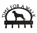 A metal hook bar with a rottweiler Dog silhouette and the words Time for a walk in an arch over the top. There are 5 hooks, It is all cut from metal with a black finish.