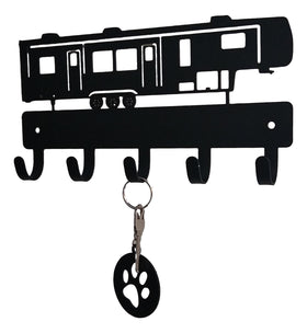 Key holder shaped like a RV with a key and paw print keychain attached on a white background
