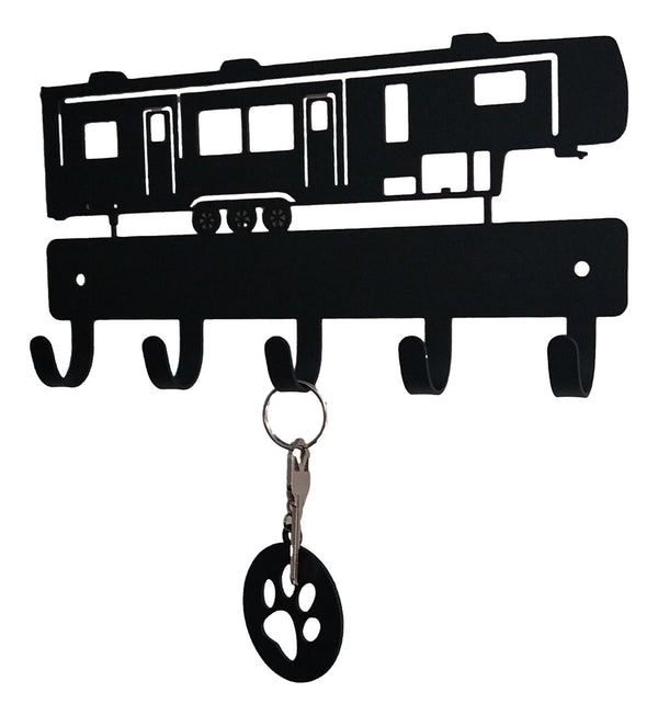 Key holder shaped like a RV with a key and paw print keychain attached on a white background