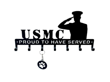 Decorative metal wall hook with USMC Proud to Have Served text and silhouette of a saluting soldier on a white background.