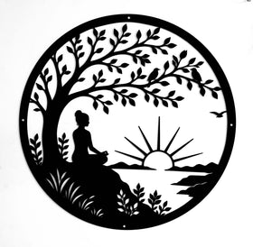 Decorative wall art with a silhouette of a person meditating under a tree, with a sunset in the background.